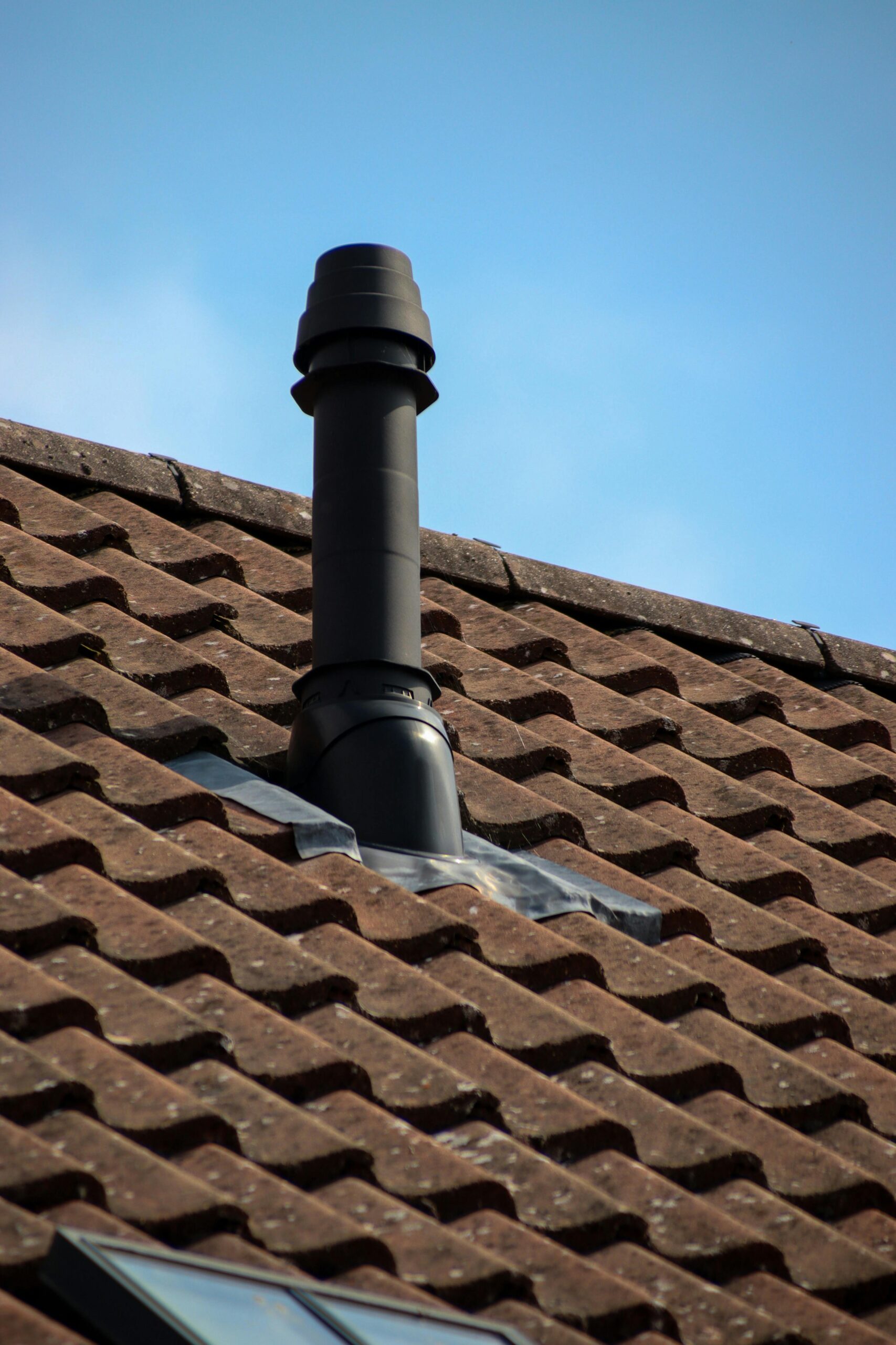 Close-up of a chimney on a tiled roof in Shaftesbury, England, showcasing architectural details.